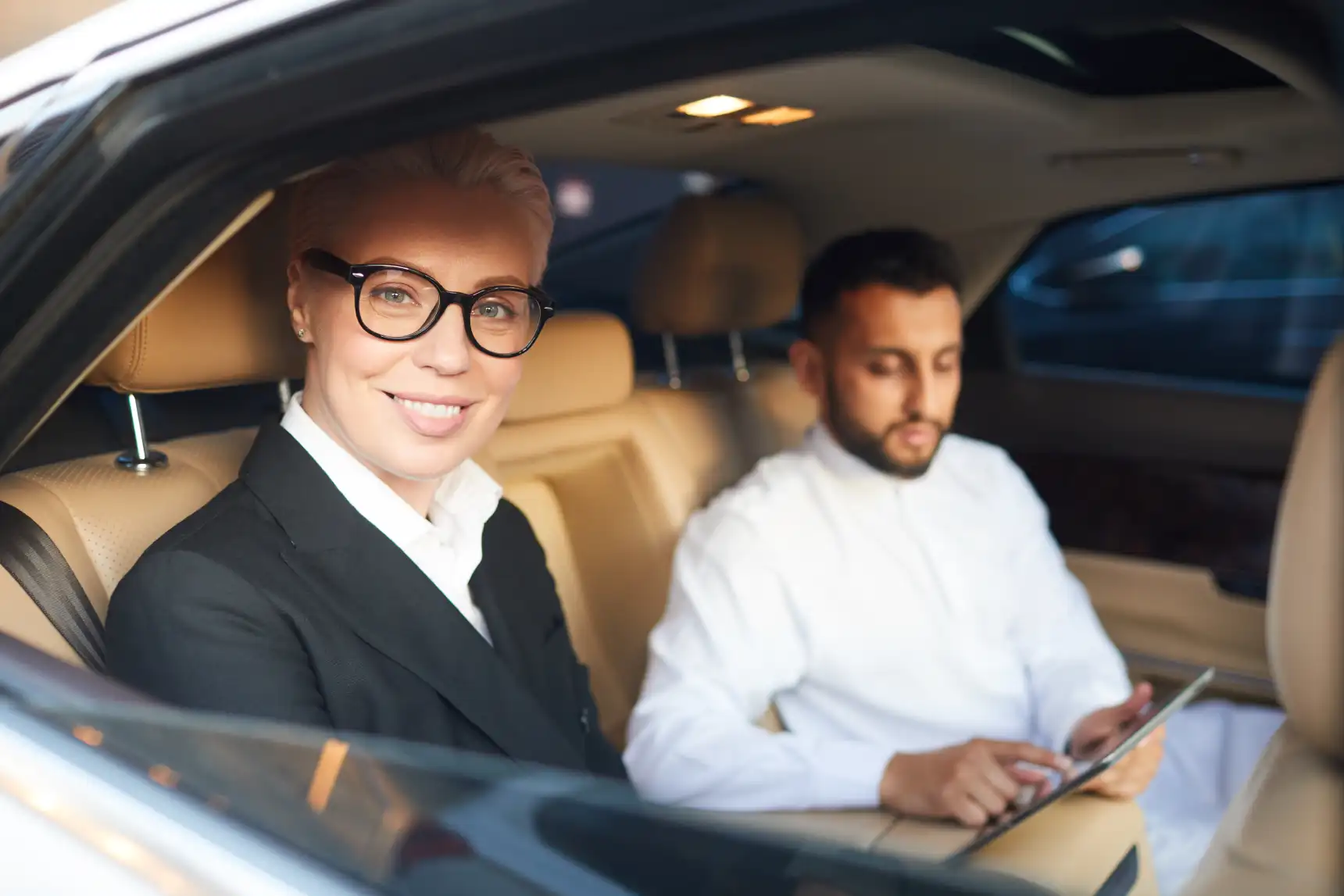 business people travelling by car