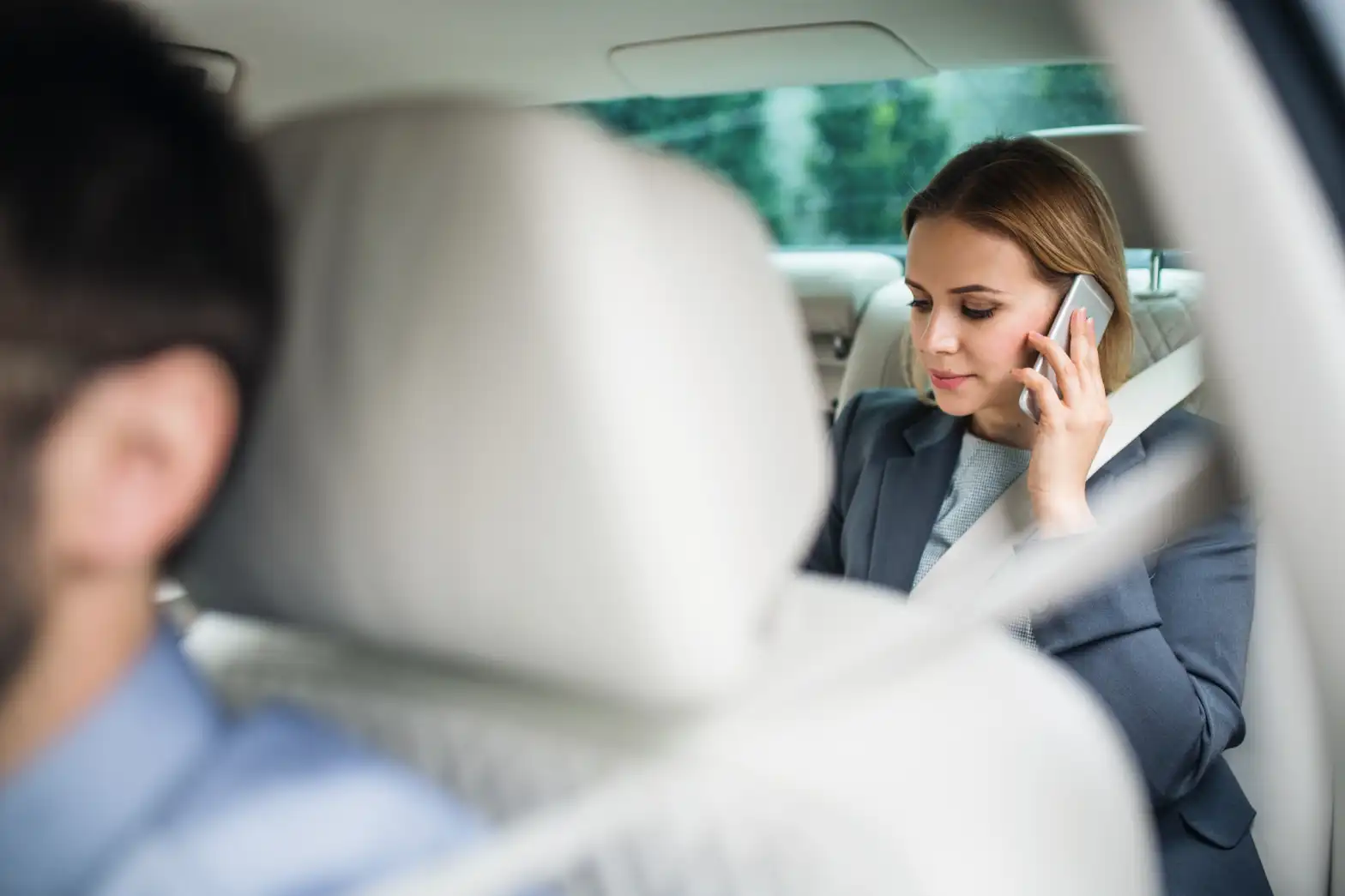 business woman with smartphone sitting on back sea